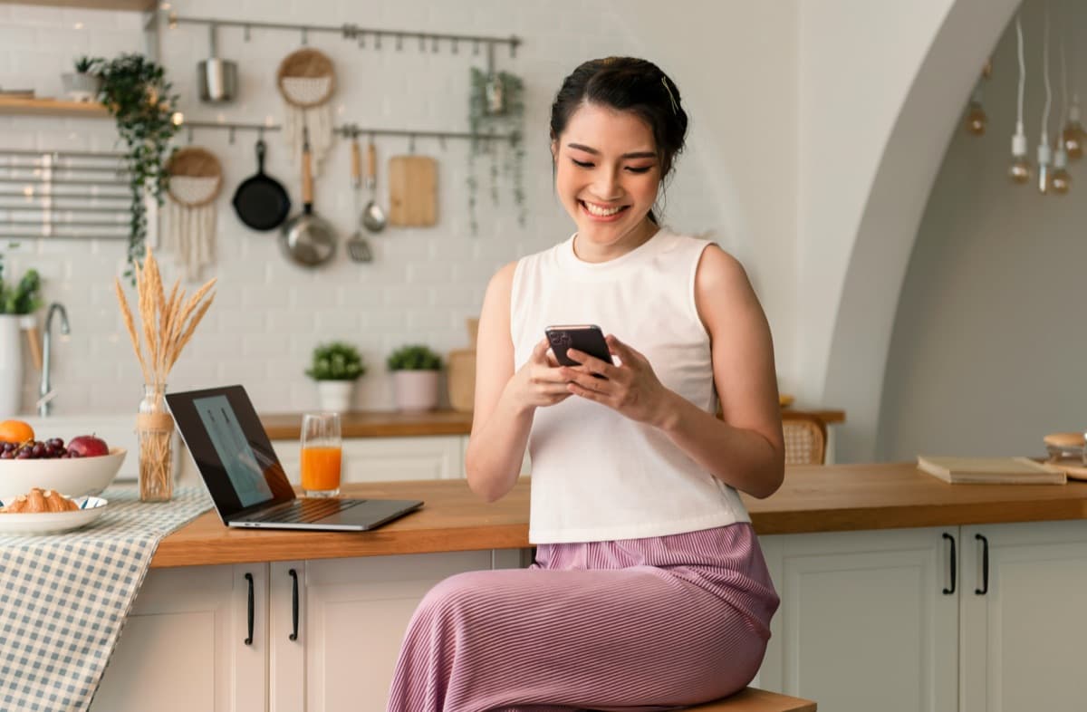 A parent reading a store update on her phone at home